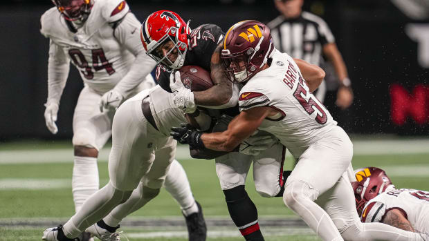 Atlanta Falcons running back Tyler Allgeier (25) is tackled by Washington Commanders linebacker Cody Barton (57) during the second half at Mercedes-Benz Stadium.